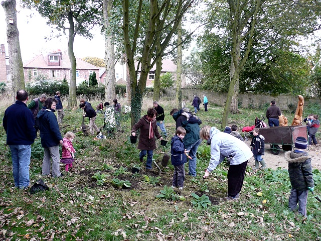 Beaver Scouts and parents planting in the woodland